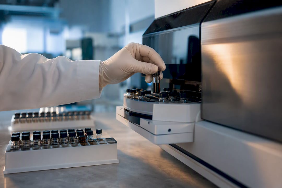 Technician placing sample vial for testing